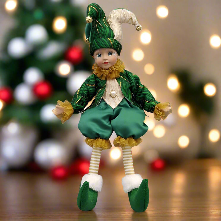 Elf doll in green and yellow outfit on a white background