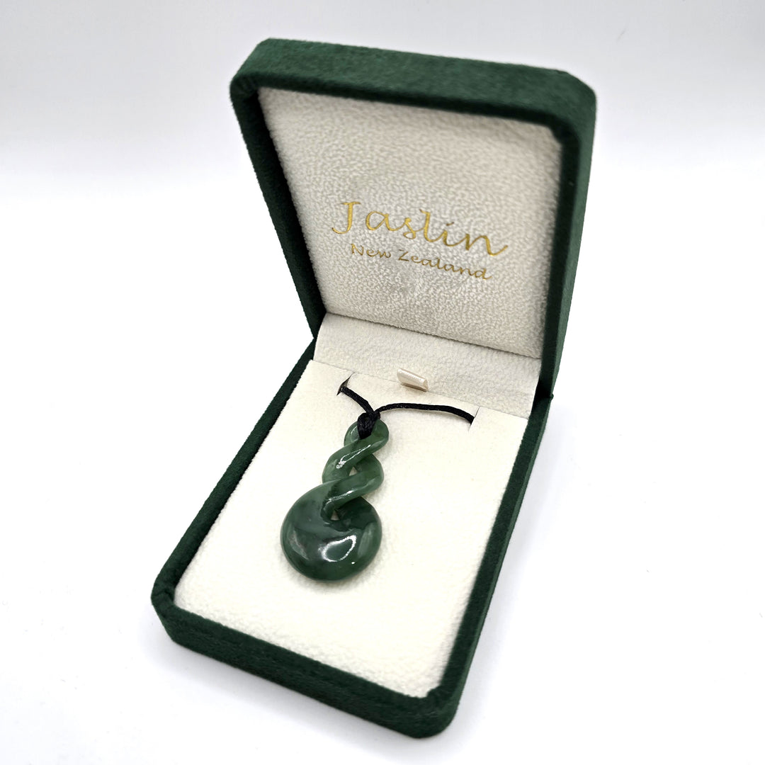 Green jade/greenstone twist necklace in a Jaslin New Zealand box on a white background