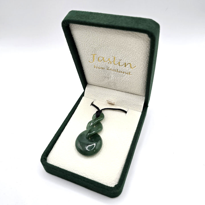 Green jade/greenstone twist necklace in a Jaslin New Zealand box on a white background