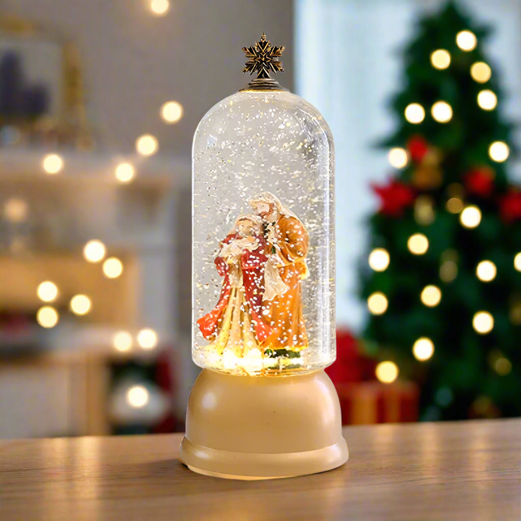 Decorative snow globe with figures inside on a white background