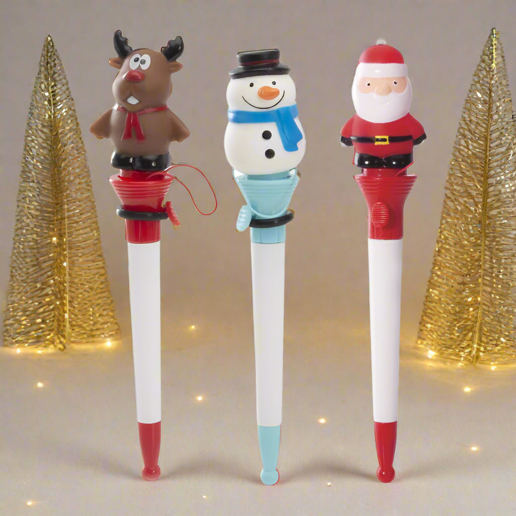Three Christmas-themed pens with reindeer, snowman, and Santa Claus designs on a white background.
