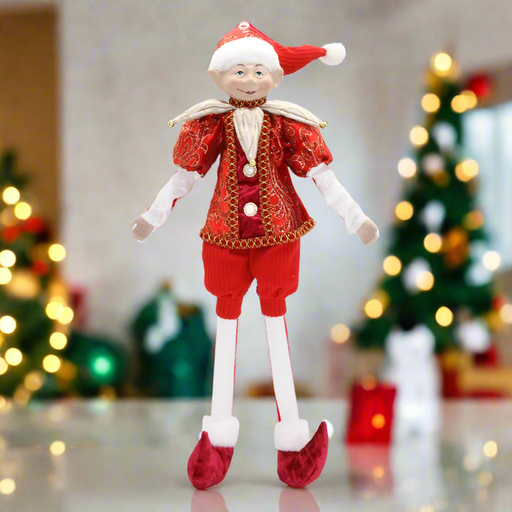 Elf doll in red and white outfit on a white background
