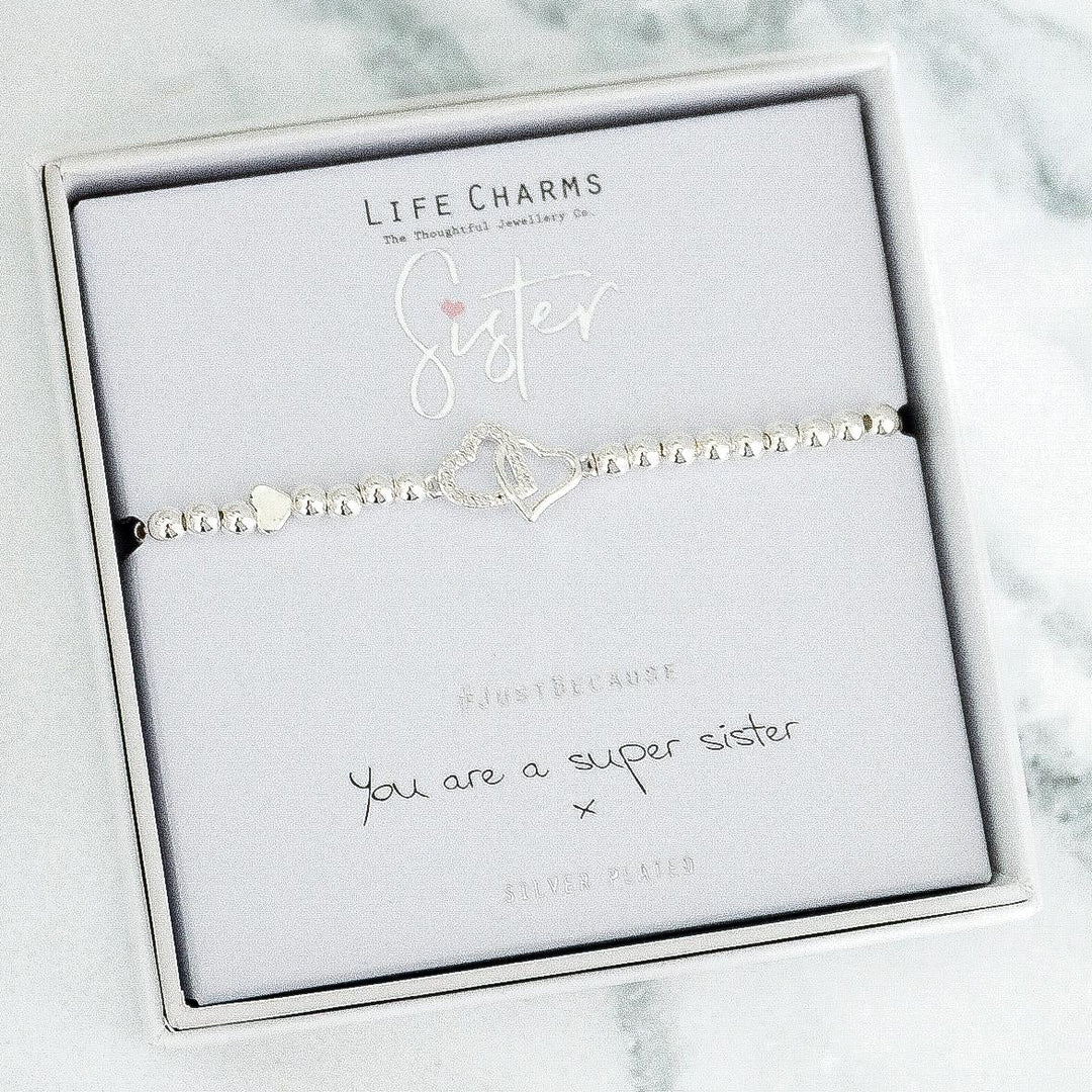 Bracelet with 'Sister' charm on a Life Charms branded card with marble background