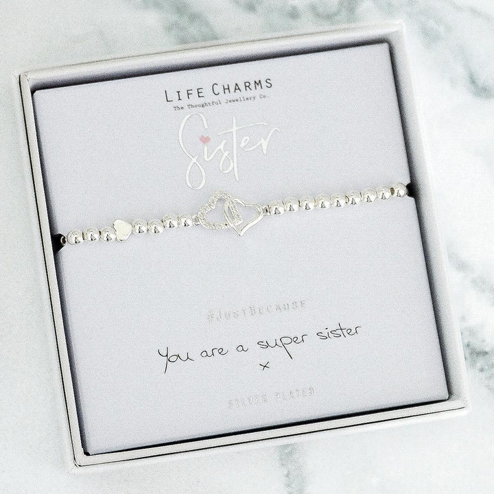 Bracelet with 'Sister' charm on a Life Charms branded card with marble background