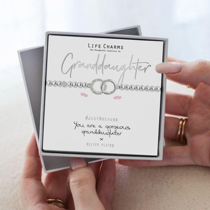Life Charms granddaughter bracelet set with card held by hands on a light background