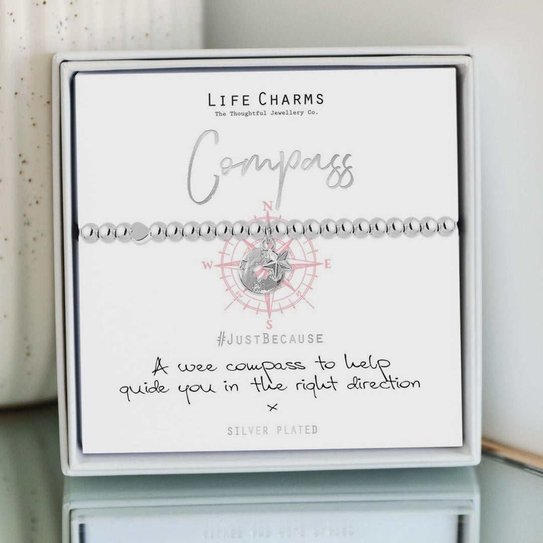 Life Charms compass bracelet packaging with a white background