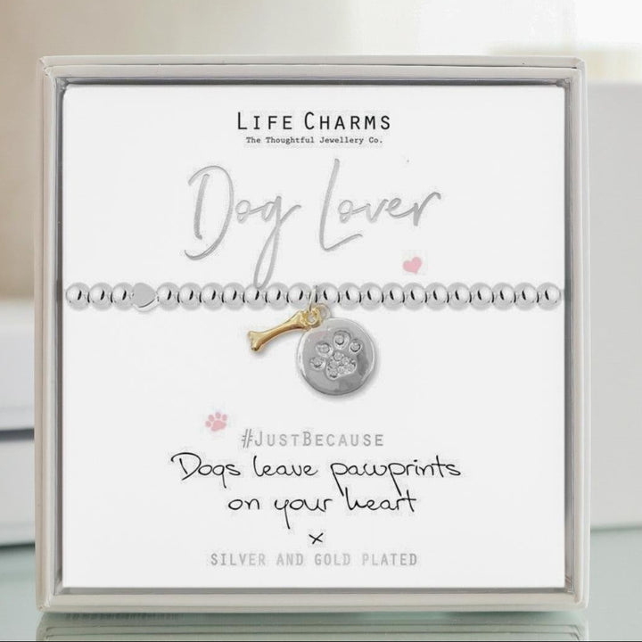Bracelet with dog charm on a 'Life Charms' card with flowers in the background