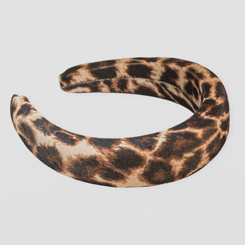 Leopard print headband on a light gray background