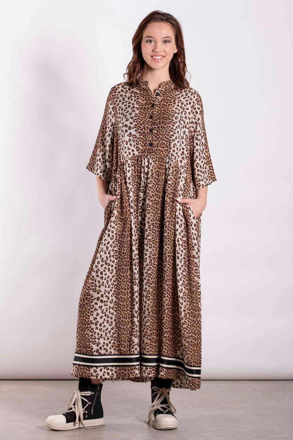 Woman wearing a leopard print dress on a white background