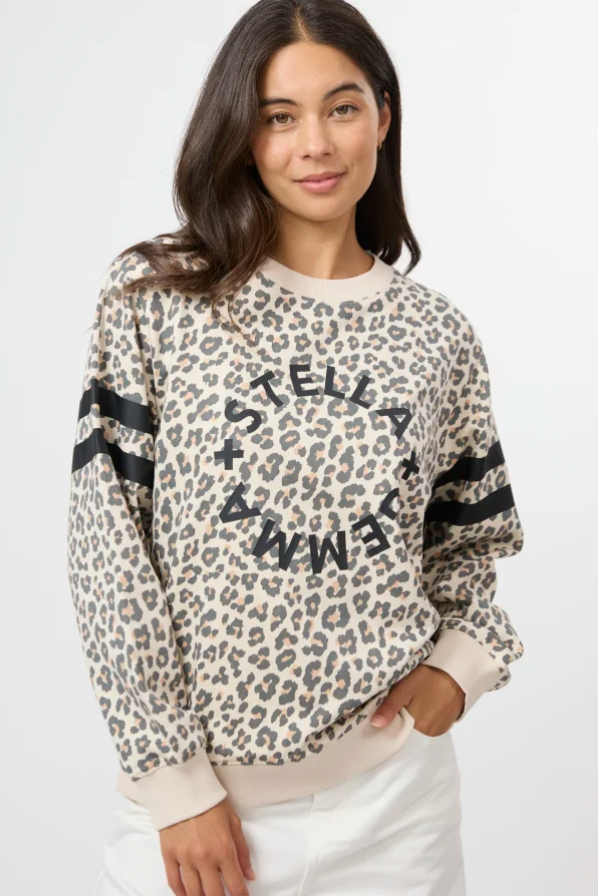 Woman wearing a leopard print sweatshirt with text on a white background