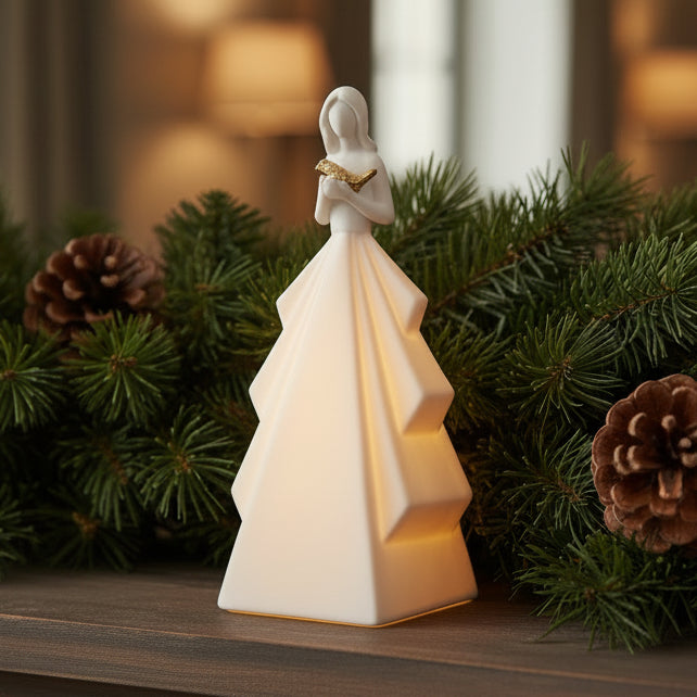 White ceramic figurine of a woman holding a heart on a white background