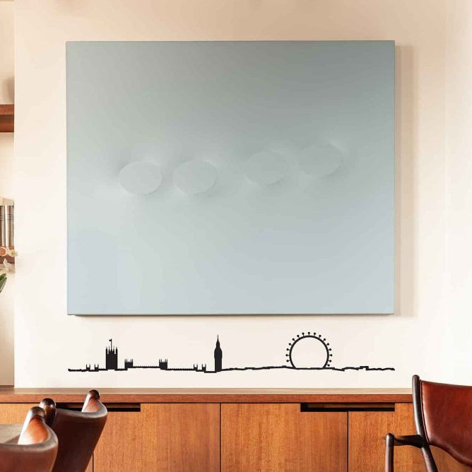 Modern kitchen with wooden cabinets, a large flat-screen TV on the wall, and chairs.