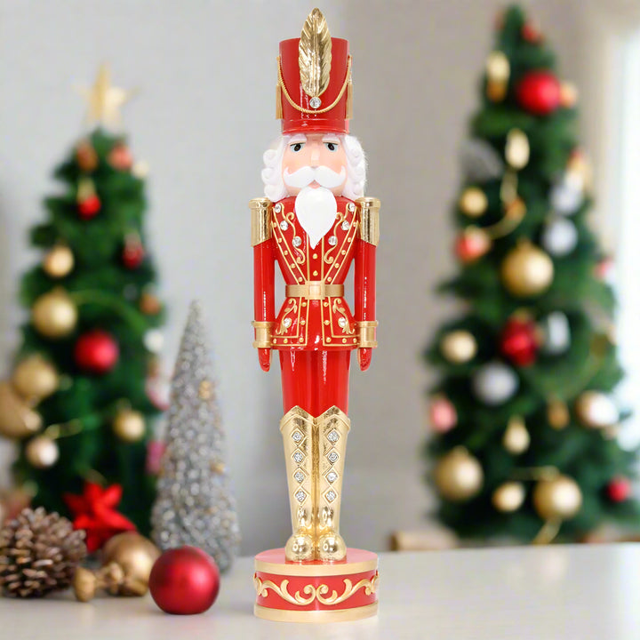 Decorative nutcracker figure in red and gold on a white background