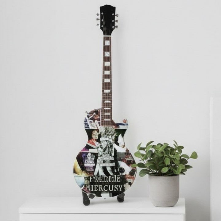 Guitar-shaped toy with Freddie Mercury design on a white background