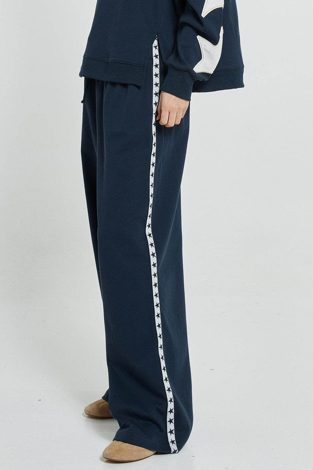 Navy tracksuit with white star design on a white background