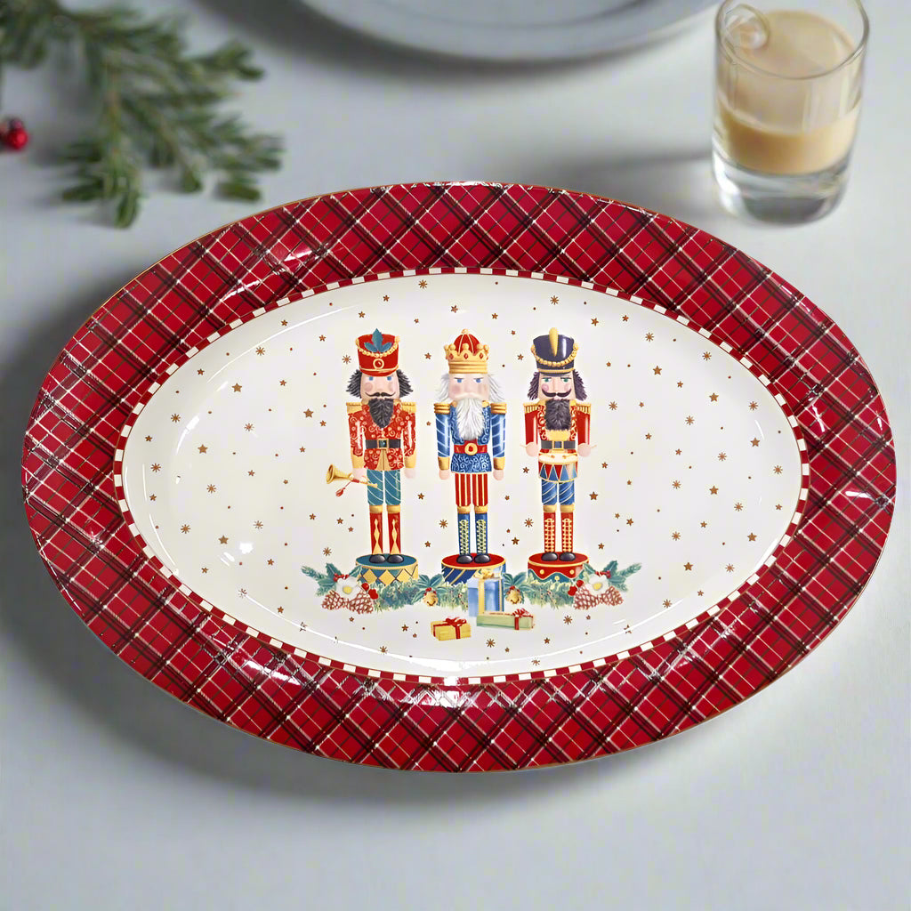 Decorative christmas plate with nutcrackers and plaid border on a white background