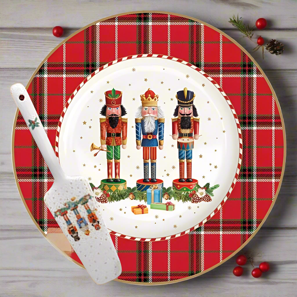Christmas-themed plate with nutcrackers and plaid border, accompanied by a spatula.
