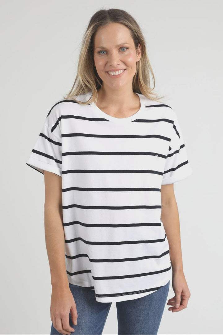 Woman wearing a black and white striped elm halli t-shirt on a plain background