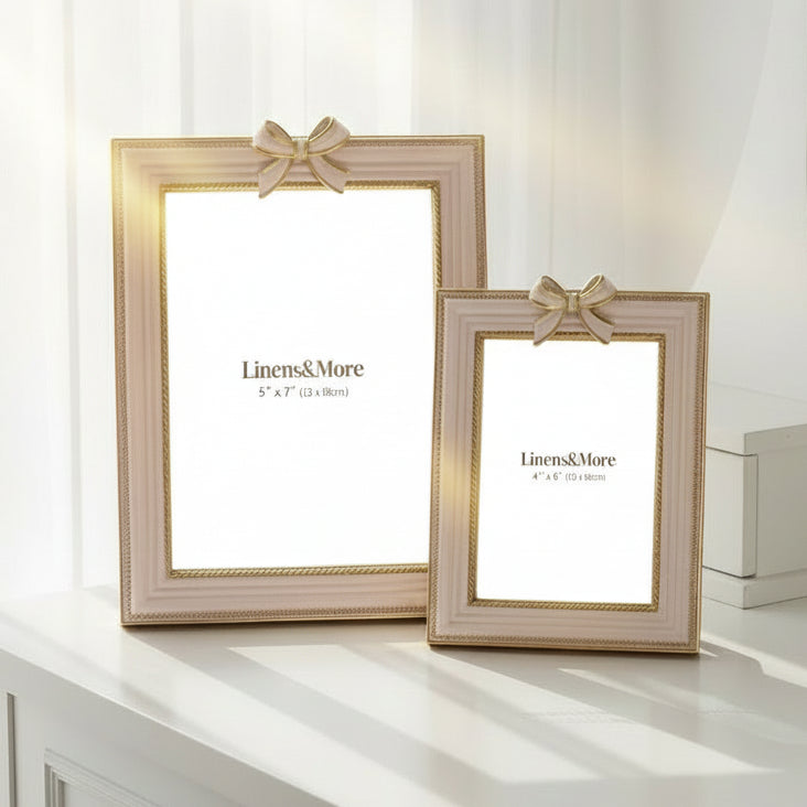 Two decorative picture frames with ribbons on a white background, branded 'Linens & More'.