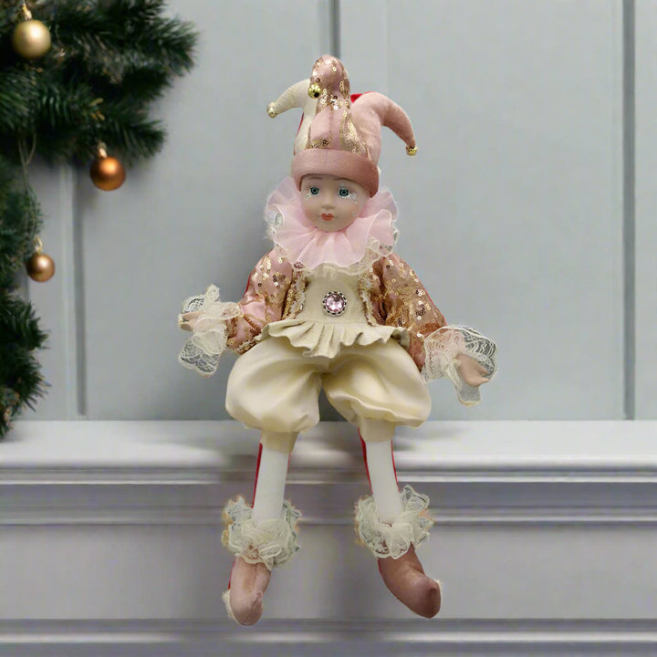 Decorative clown figurine with pink and beige outfit on a white background