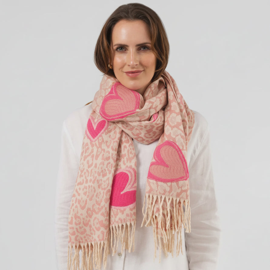 Woman wearing a pink heart patterned scarf on a white background