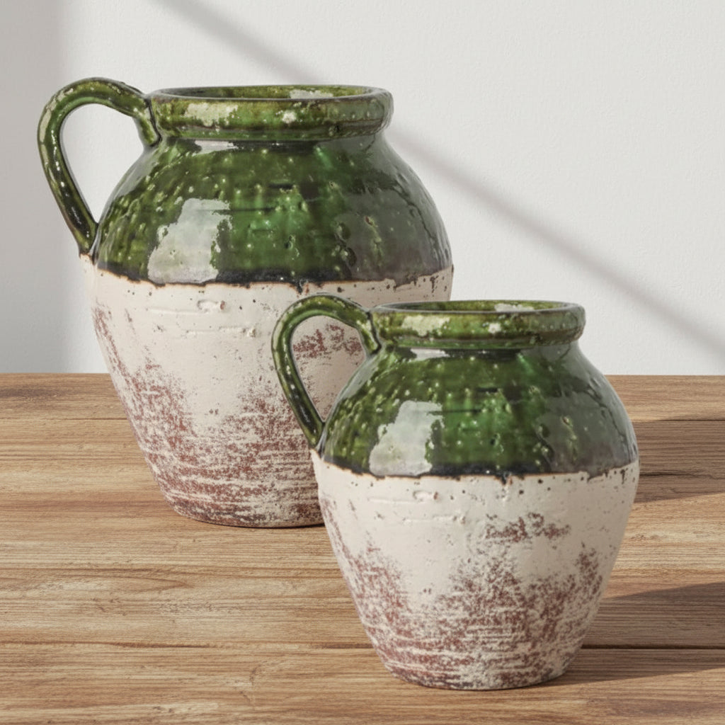 Two ceramic jars with green and white glaze on a white background