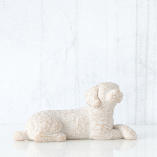 SMALL LYING WHITE DOG