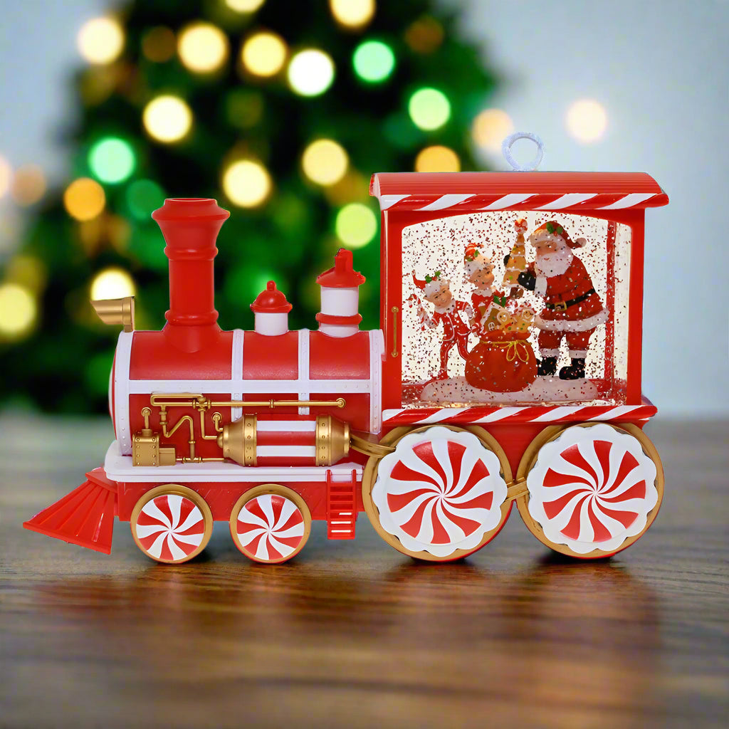 Red and white toy train with Santa Claus design on a white background