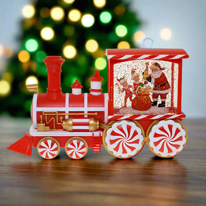 Red and white toy train with Santa Claus design on a white background