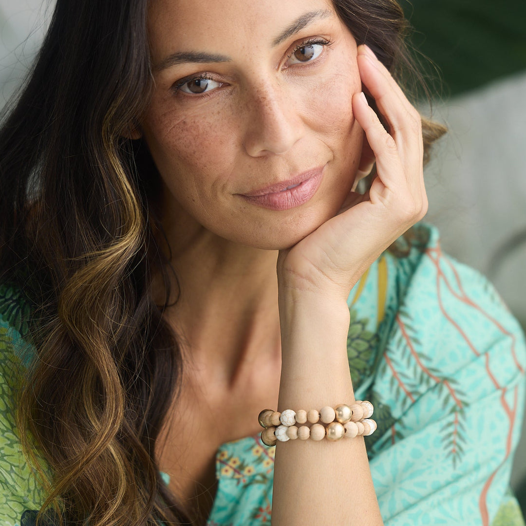 Woman wearing a green embroidered dress with a blurred background