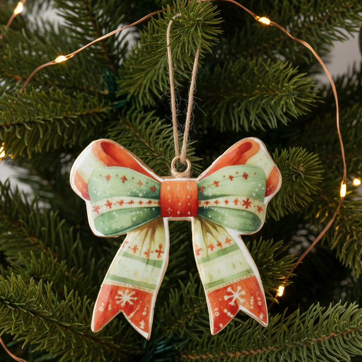 Decorative bow ornament with red and green pattern on a white background