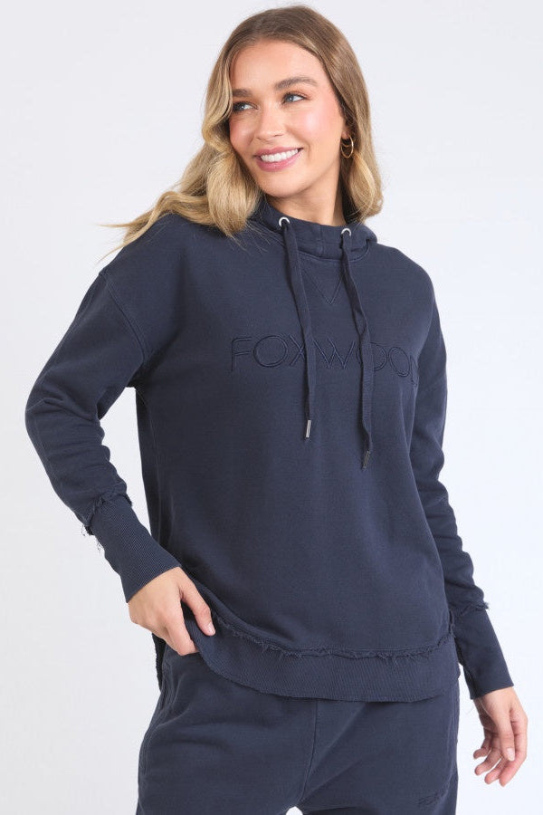 Woman wearing a navy blue hoodie with a brand logo on a white background