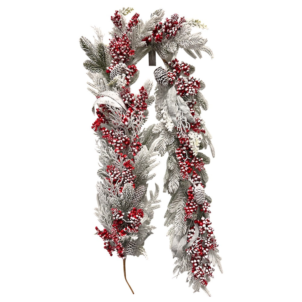 Decorative garland with red berries and white snow-like texture on a white background
