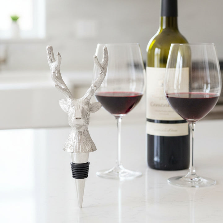 Silver deer-shaped bottle stopper on a white background