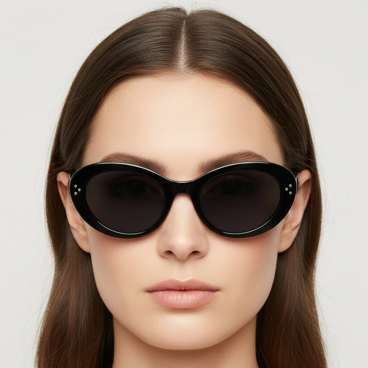 Black cat-eye sunglasses on a light gray background