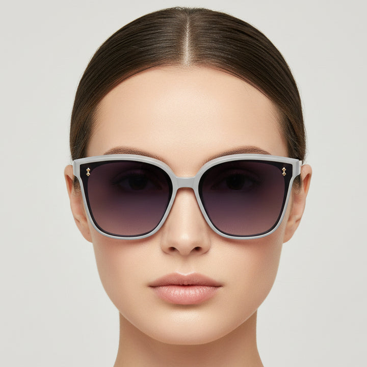 Sunglasses with gradient purple lenses on a light gray background