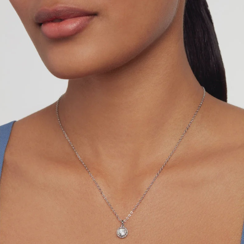 TED BAKER SILVER Necklace with a pendant worn by a person on a plain background