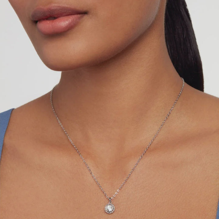TED BAKER SILVER Necklace with a pendant worn by a person on a plain background