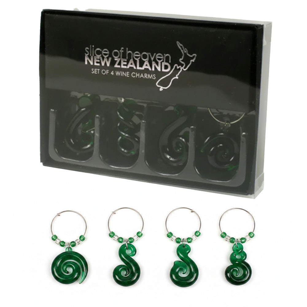 A set of four green glass wine charm strap clips displayed below their black retail packaging box. The charms feature spiral designs and small green beads, with the brand 'slice of heaven NEW ZEALAND' printed on the box.