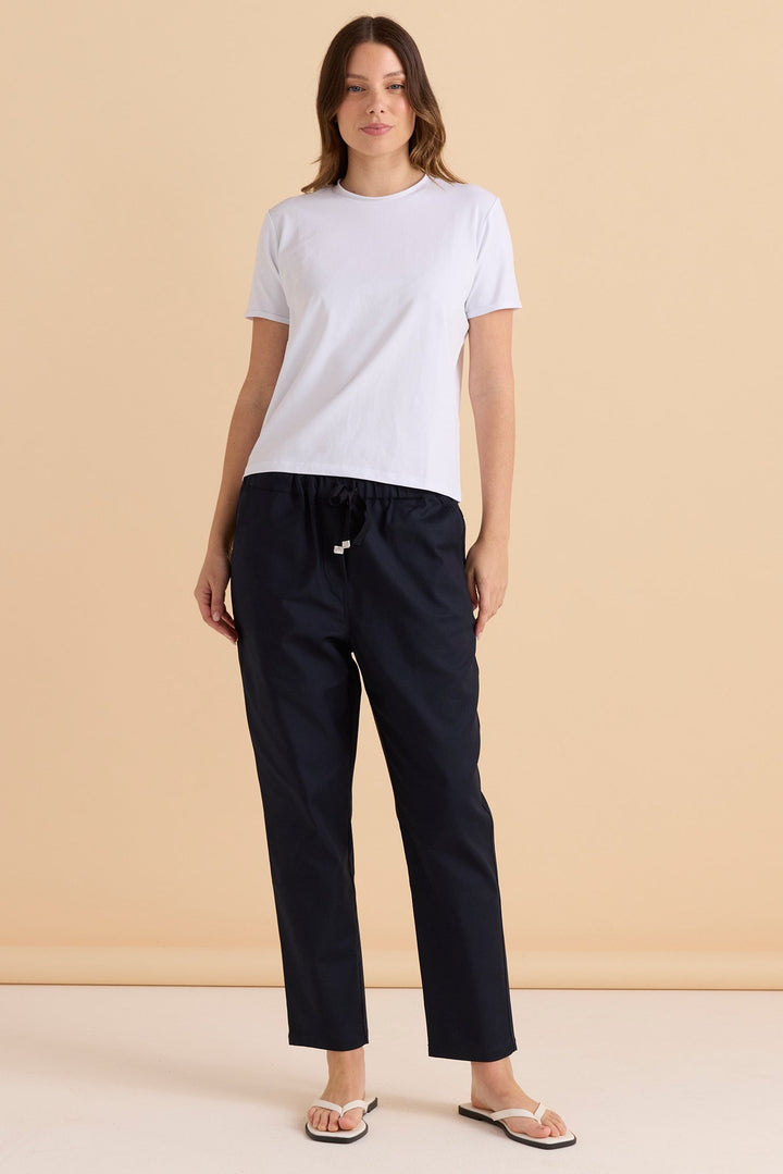 MODEL WEARING THE BETTY BASIC STRETCH KENZIE JOGGER PANTS IN NAVY.