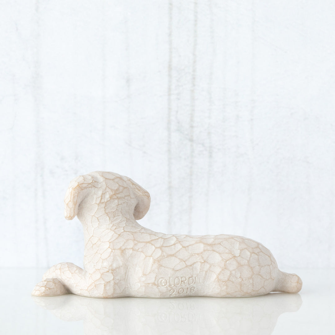 SMALL LYING WHITE DOG