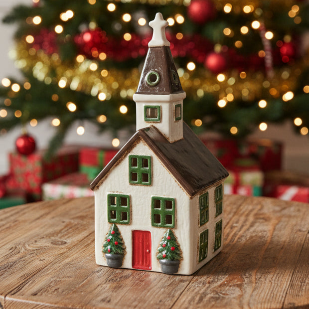 Small model of a house with a clock tower on a white background