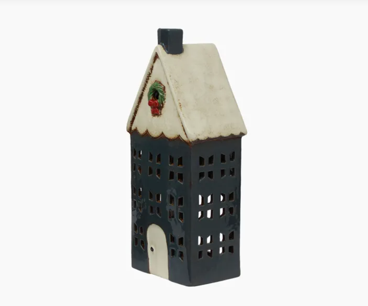 Decorative house-shaped lantern with a white roof and black body on a white background