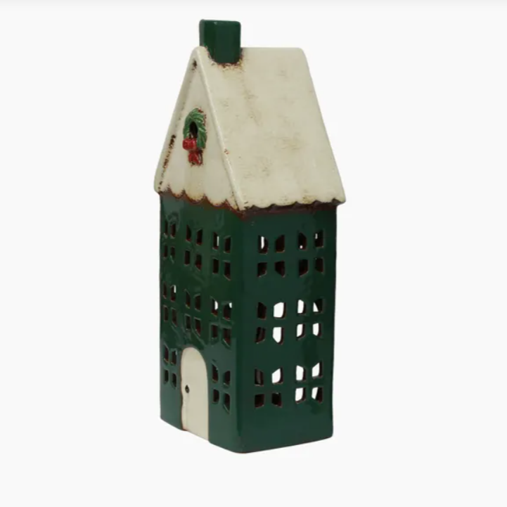 Decorative house-shaped lantern with green base and white roof on a white background