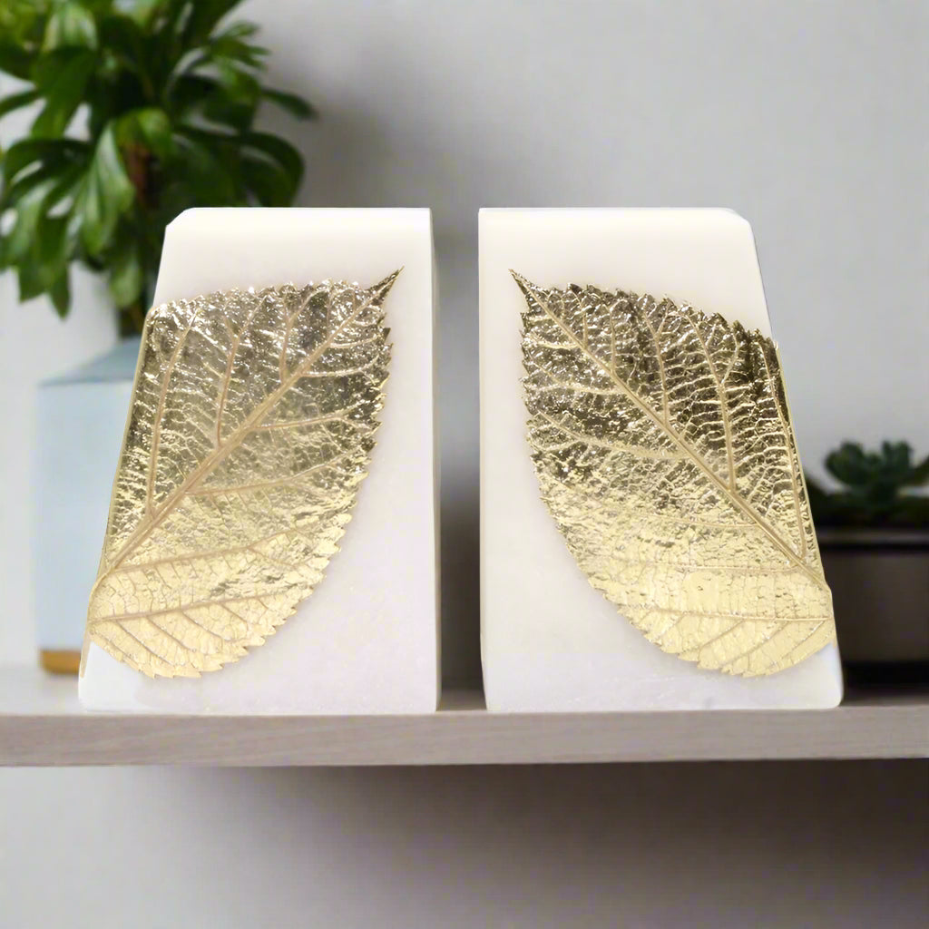 Gold leaf & white bookends on a white background